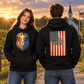 Couple wearing Conviction hoodies with a church, American flag, and evening sunlight in the background