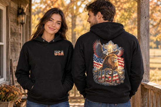 Two friends wearing USA Faith and Courage hoodies on an autumn porch